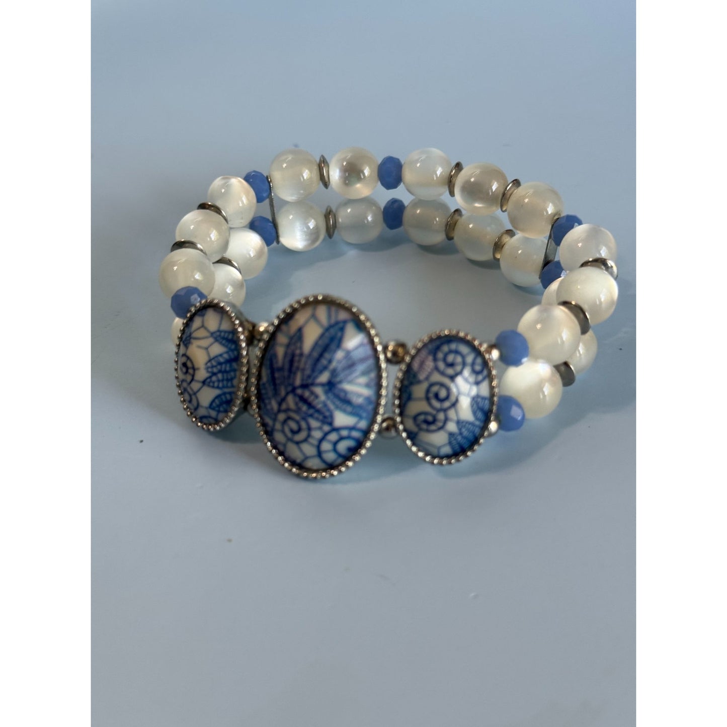 Blue Ice Glass Beaded Stretch Bracelet With Floral Embossed Porcelain Accents