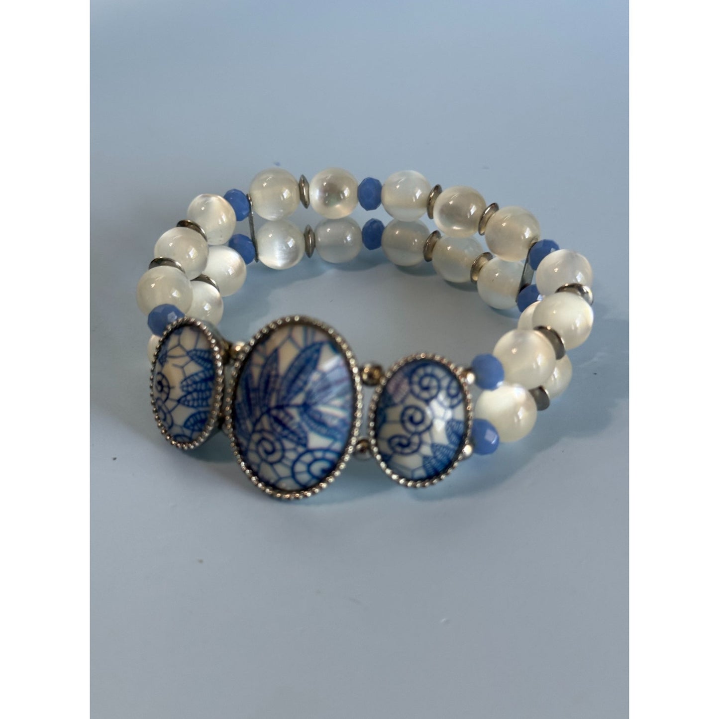 Blue Ice Glass Beaded Stretch Bracelet With Floral Embossed Porcelain Accents