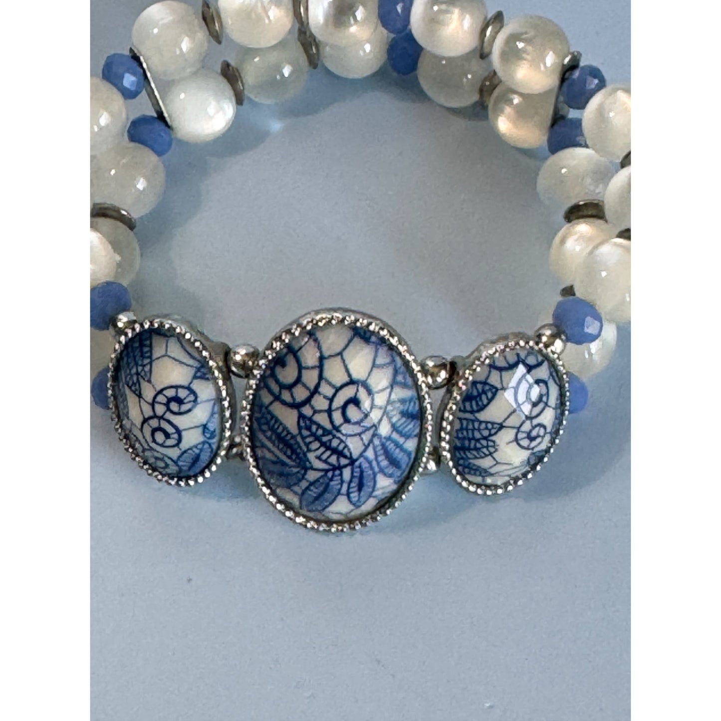 Blue Ice Glass Beaded Stretch Bracelet With Floral Embossed Porcelain Accents