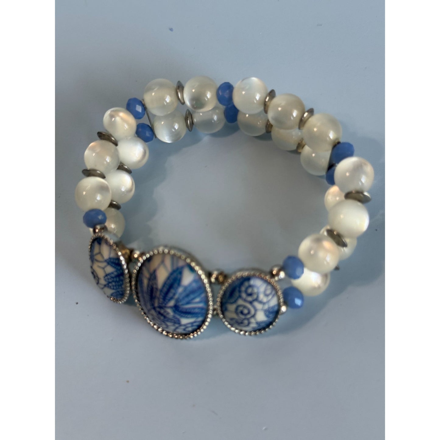 Blue Ice Glass Beaded Stretch Bracelet With Floral Embossed Porcelain Accents